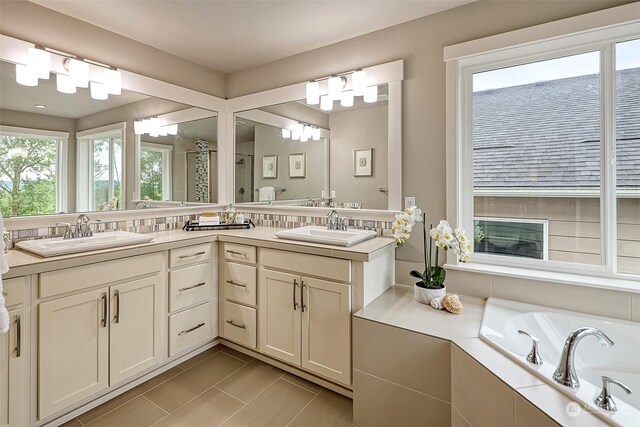 bathroom with vanity and separate shower and tub