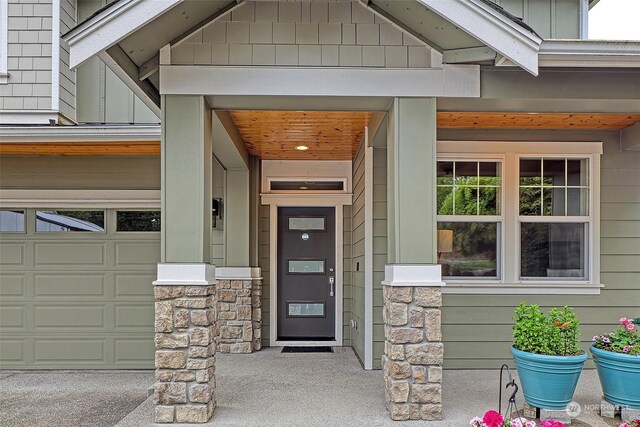 view of exterior entry with a garage