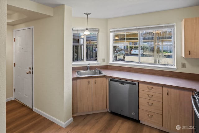 kitchen with pendant lighting, appliances with stainless steel finishes, sink, and dark hardwood / wood-style flooring