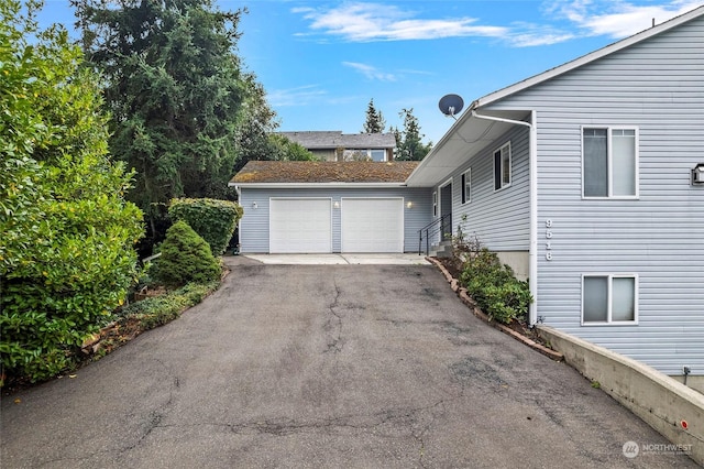 view of property exterior with aphalt driveway