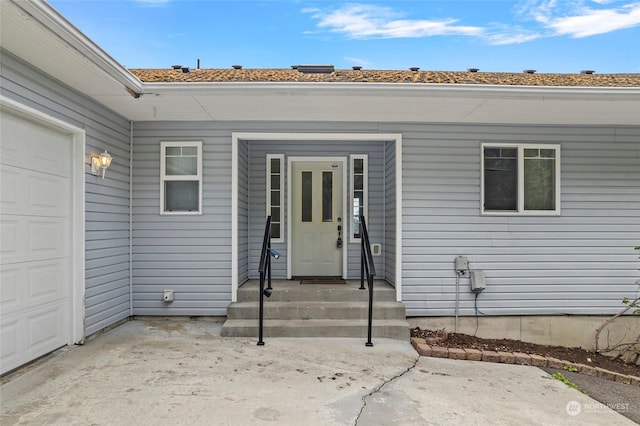 doorway to property with a garage