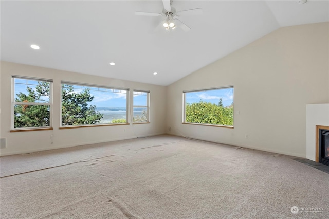 unfurnished living room featuring a fireplace with flush hearth, carpet flooring, vaulted ceiling, and recessed lighting