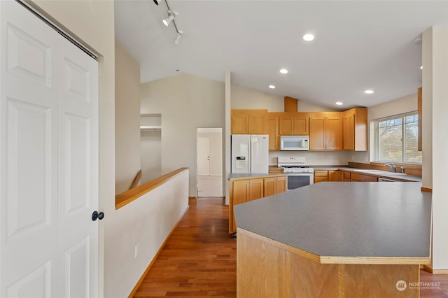 kitchen with a sink, white appliances, recessed lighting, dark wood-type flooring, and lofted ceiling