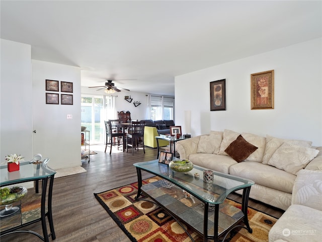 living room featuring dark hardwood / wood-style flooring and ceiling fan