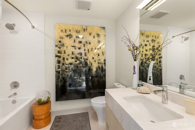 full bathroom featuring tiled shower / bath, vanity, tile patterned flooring, and toilet