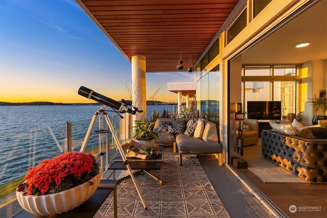 view of patio featuring a dock, a water view, and an outdoor hangout area