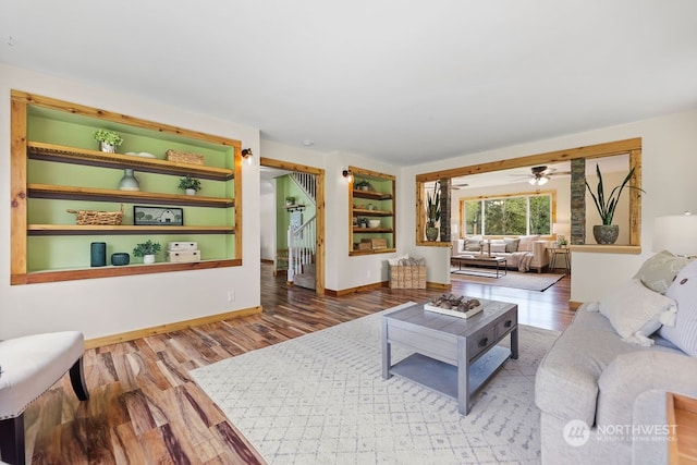 living room featuring ceiling fan and hardwood / wood-style flooring