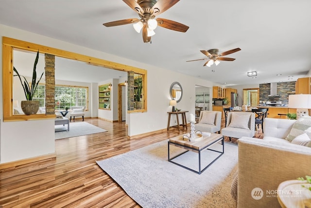 living room featuring light hardwood / wood-style floors and ceiling fan