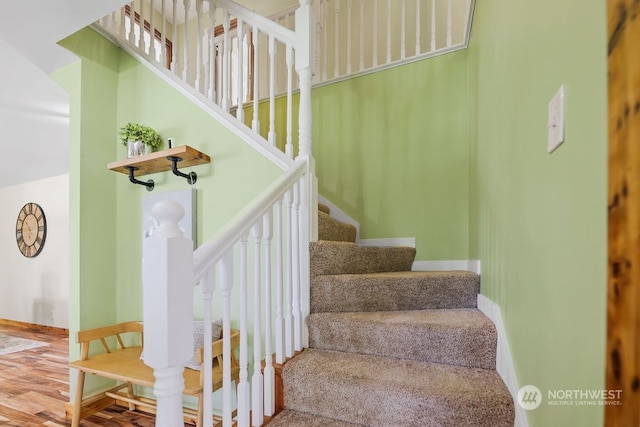 stairs featuring hardwood / wood-style flooring