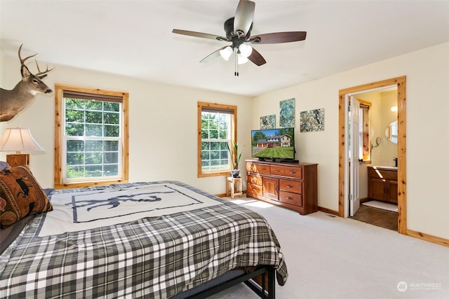 carpeted bedroom with connected bathroom and ceiling fan