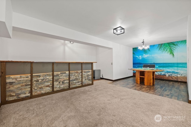 interior space with a notable chandelier and carpet flooring