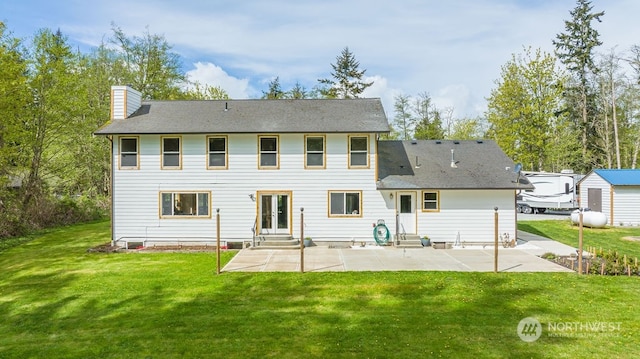 rear view of house featuring a patio and a yard