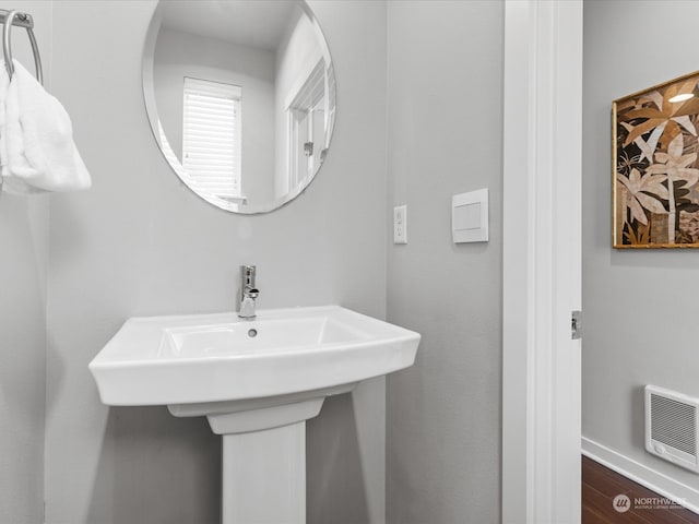 bathroom with wood-type flooring and heating unit