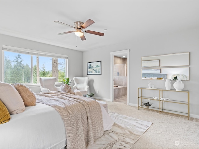 bedroom featuring connected bathroom, ceiling fan, and light colored carpet