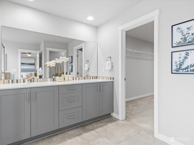 bathroom featuring tile patterned flooring, vanity, and ceiling fan