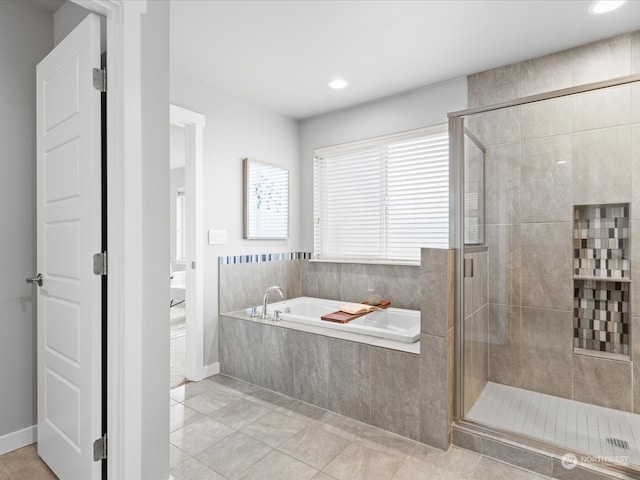 bathroom with plus walk in shower and tile patterned flooring