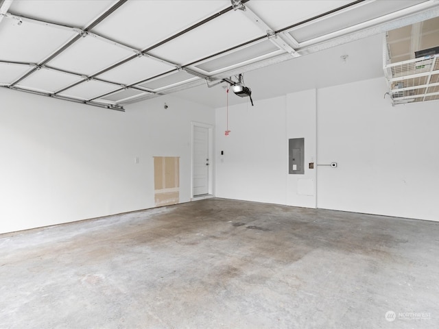 garage with a garage door opener and electric panel