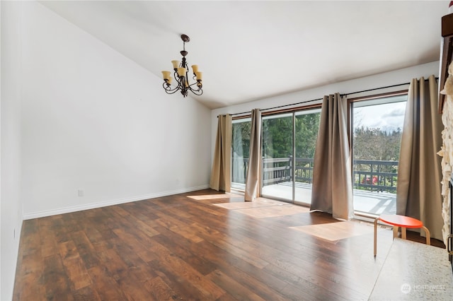 unfurnished room featuring vaulted ceiling, a chandelier, and hardwood / wood-style floors