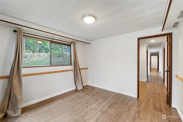 unfurnished room with light wood-type flooring