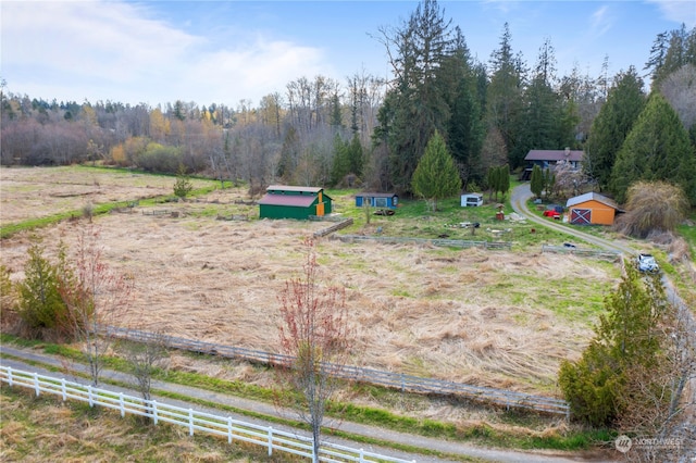 view of yard with a rural view and an outbuilding