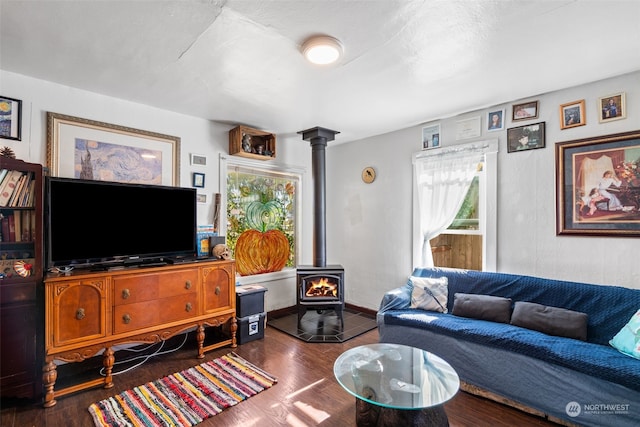 living room with a wood stove and dark hardwood / wood-style floors