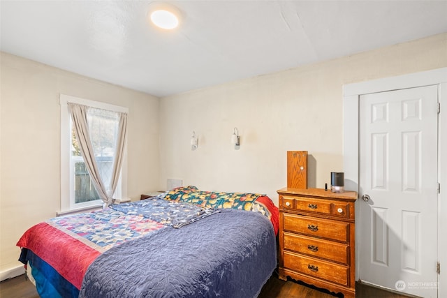 bedroom with dark hardwood / wood-style flooring