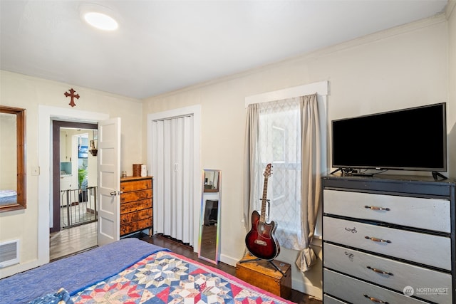 bedroom with dark wood-type flooring and ornamental molding