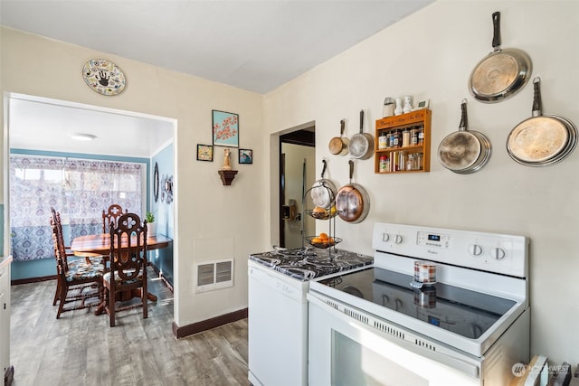 kitchen with white range, white electric stove, and light hardwood / wood-style flooring