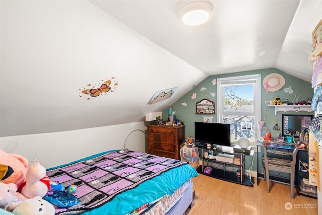 bedroom featuring lofted ceiling and hardwood / wood-style floors