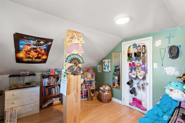 interior space with lofted ceiling and hardwood / wood-style flooring