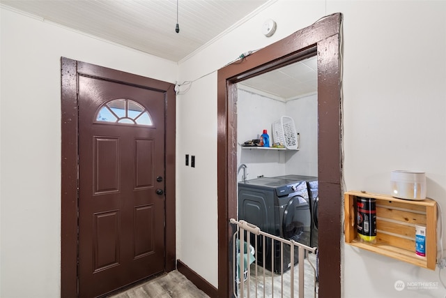 entryway featuring independent washer and dryer and light hardwood / wood-style flooring