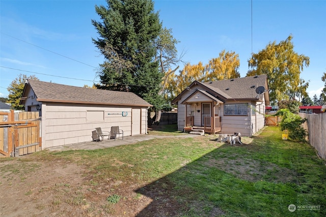 rear view of property featuring a yard and a patio area