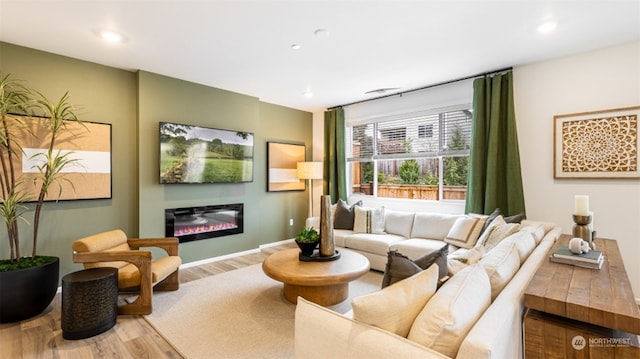 211 179th St SE, Bothell, WA 98021 - living room featuring wood finished floors, a glass covered fireplace, and recessed lighting