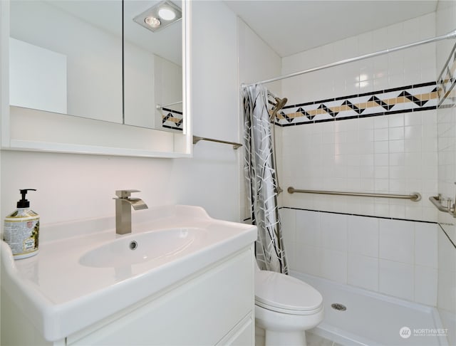 bathroom with walk in shower, vanity, and toilet