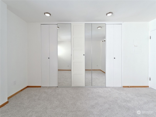 unfurnished bedroom featuring light carpet