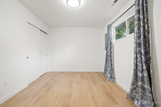 spare room with light hardwood / wood-style flooring