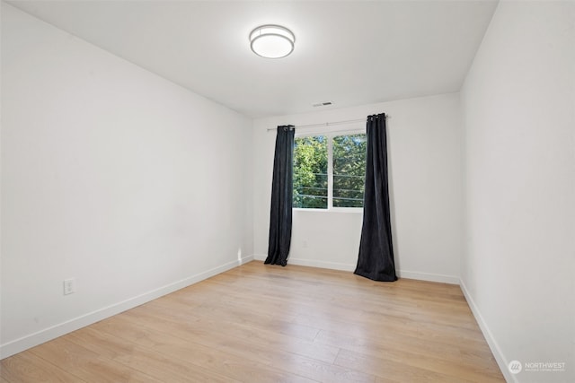 empty room with light hardwood / wood-style floors