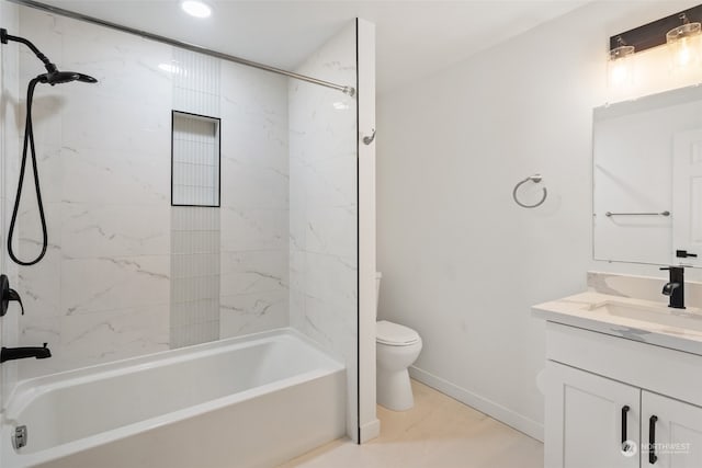 full bathroom featuring tile patterned floors, tiled shower / bath, vanity, and toilet