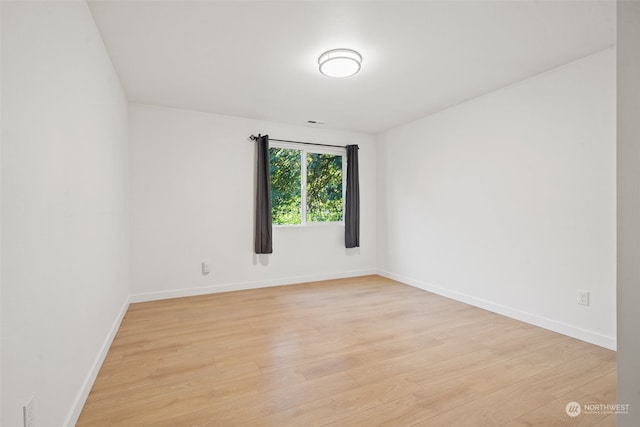 empty room with light hardwood / wood-style floors