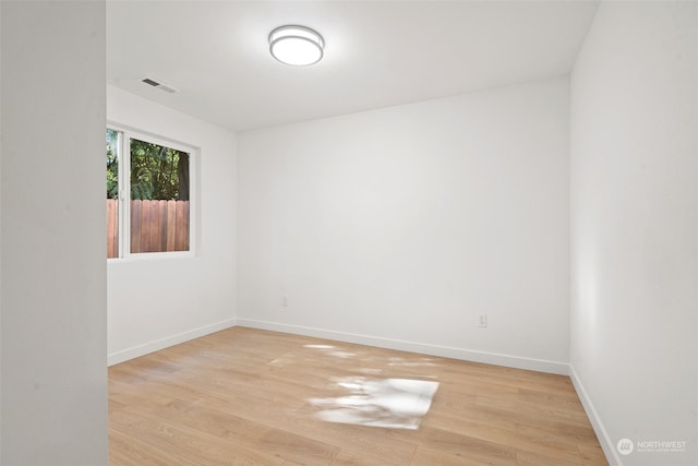 empty room with light hardwood / wood-style flooring