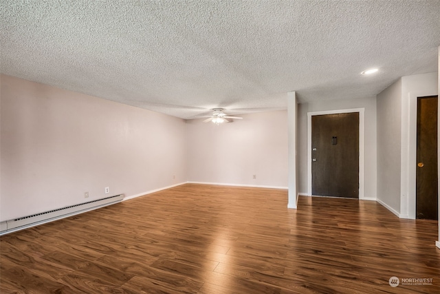 spare room with ceiling fan, a textured ceiling, baseboard heating, and dark hardwood / wood-style flooring