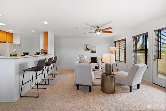 carpeted living room featuring ceiling fan