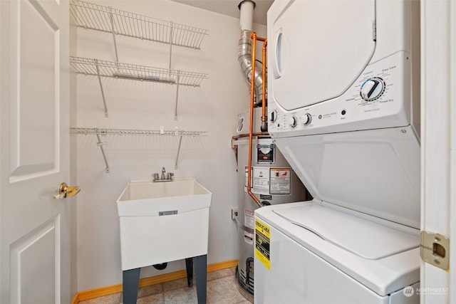 laundry room featuring stacked washer and clothes dryer and sink