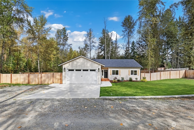 view of front of property featuring a garage and a front yard