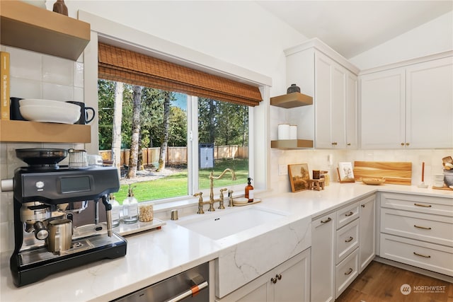 kitchen featuring white cabinets, lofted ceiling, plenty of natural light, and sink