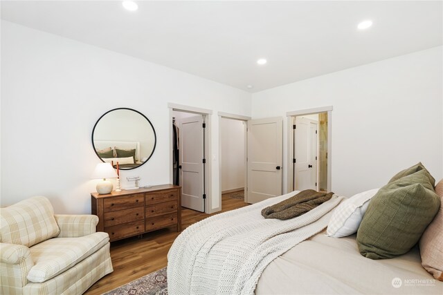 bedroom with hardwood / wood-style flooring