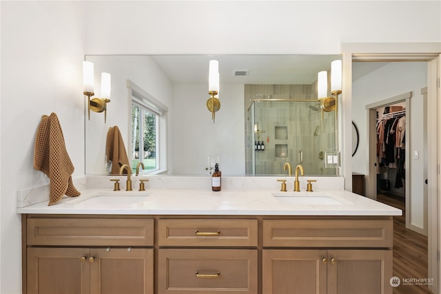 bathroom featuring vanity, hardwood / wood-style flooring, and a shower with shower door