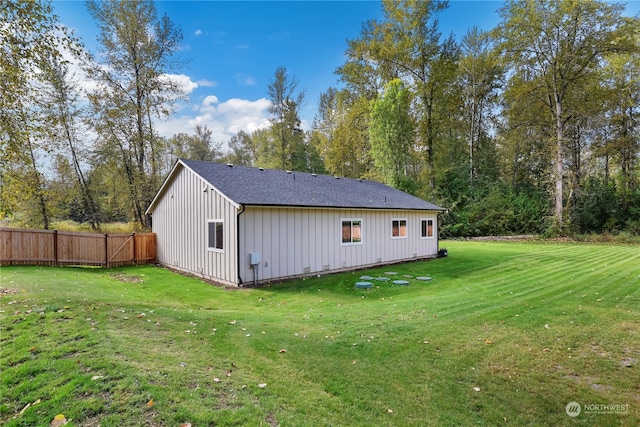 view of side of home with a lawn