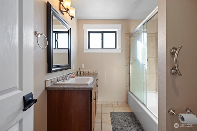 bathroom with tile patterned flooring, vanity, and bath / shower combo with glass door