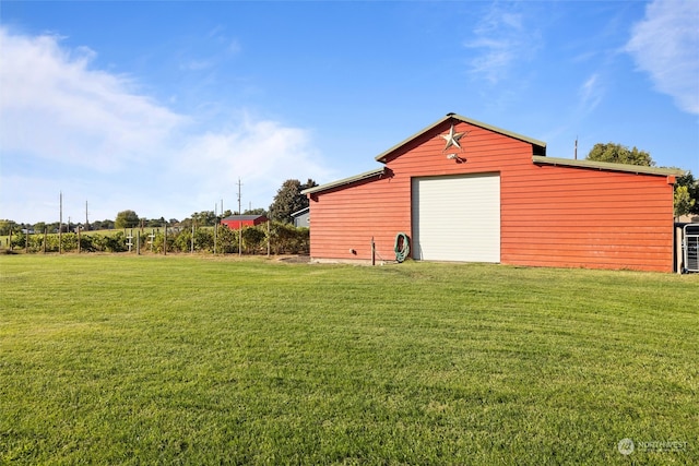 view of yard featuring a garage and an outbuilding